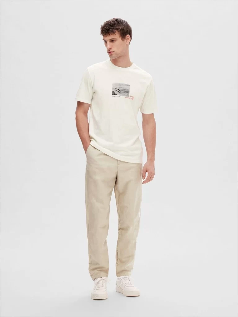 Minimalist graphic tee paired with tailored trousers for a modern outfit